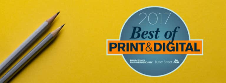 2017 Best of Print & Digital award badge beside two pencils on a yellow background