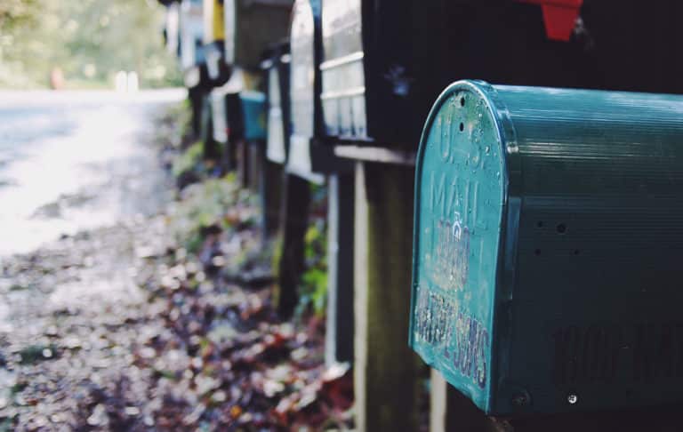 Row of roadside mailboxes along a country lane