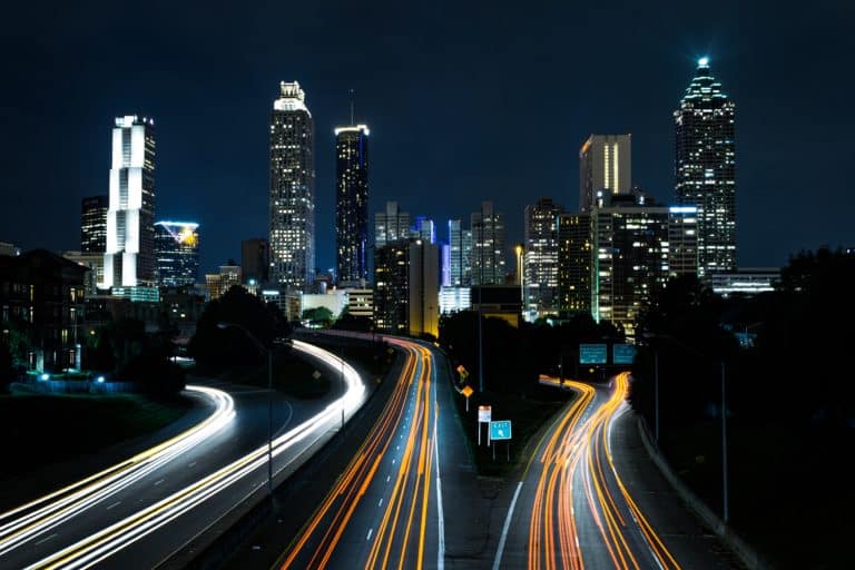 Atlanta skyline at night with highway light trails in the foreground